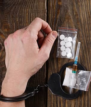man handcuffed with drugs